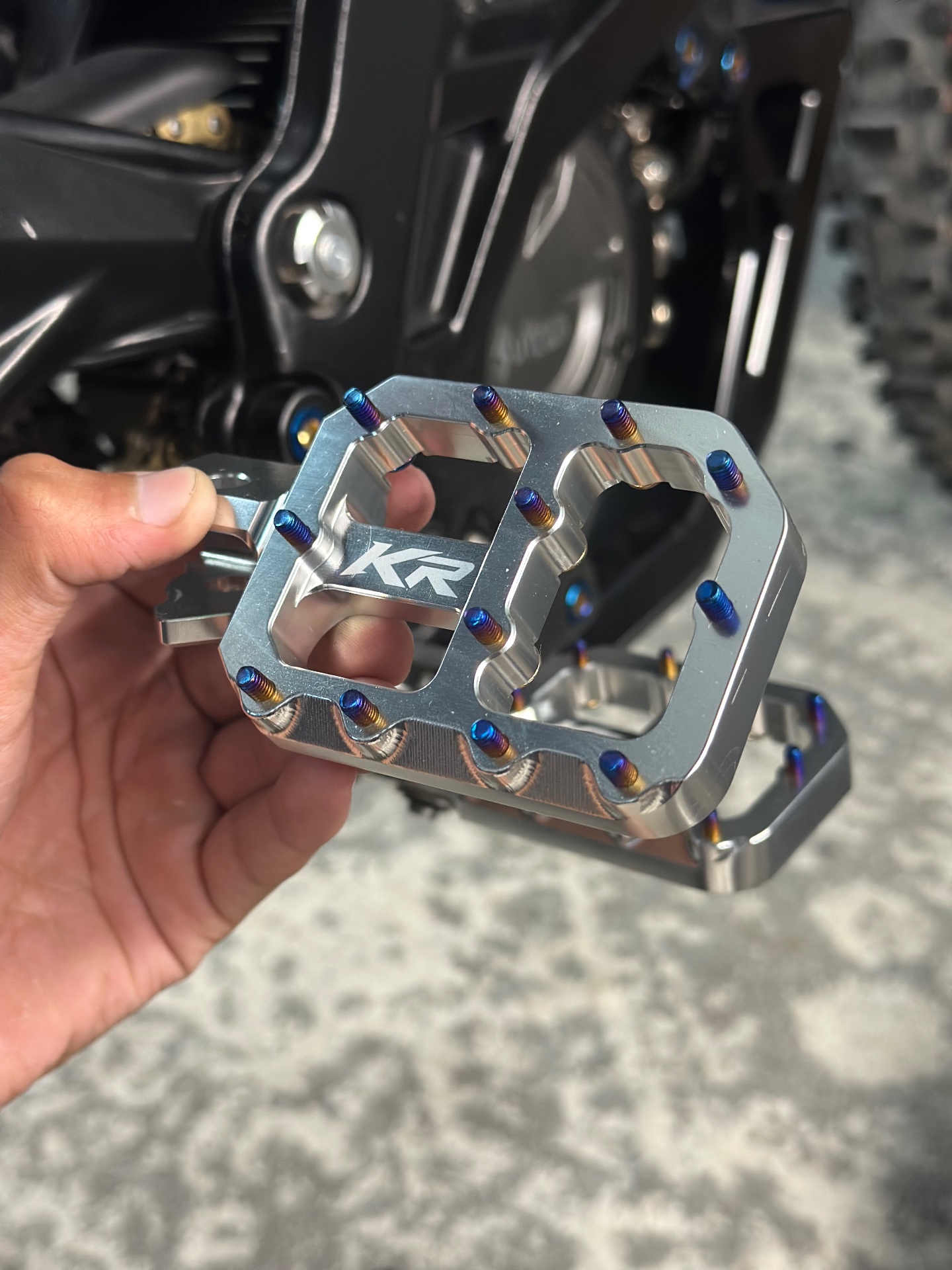 Chrome Kinetic Racing peg held in hand showing the finished billet design